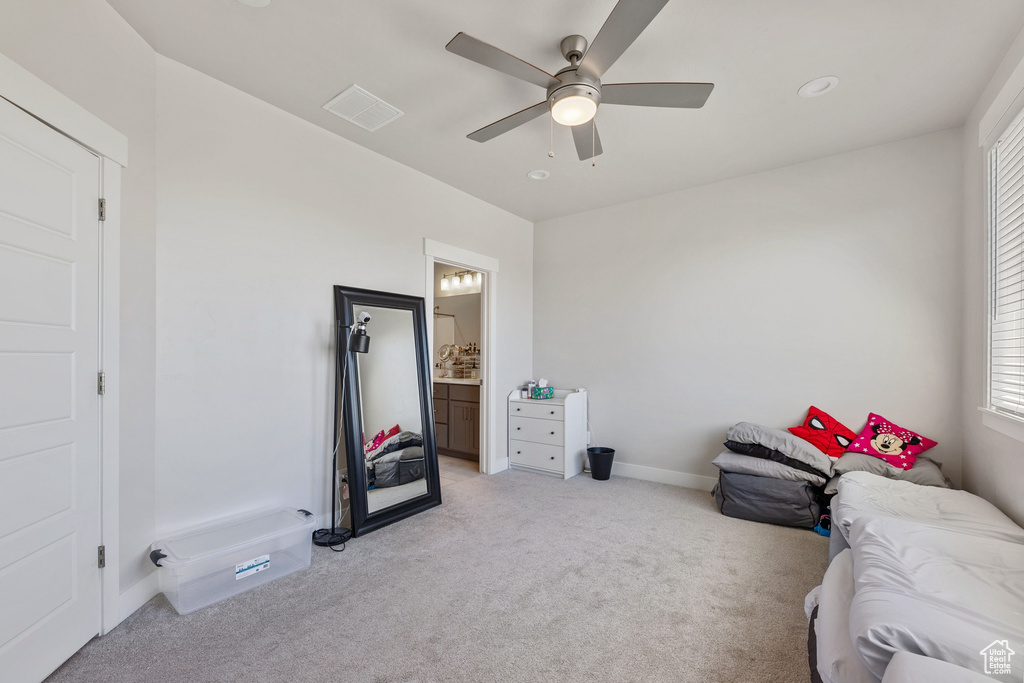Bedroom featuring baseboards, light colored carpet, multiple windows, and visible vents