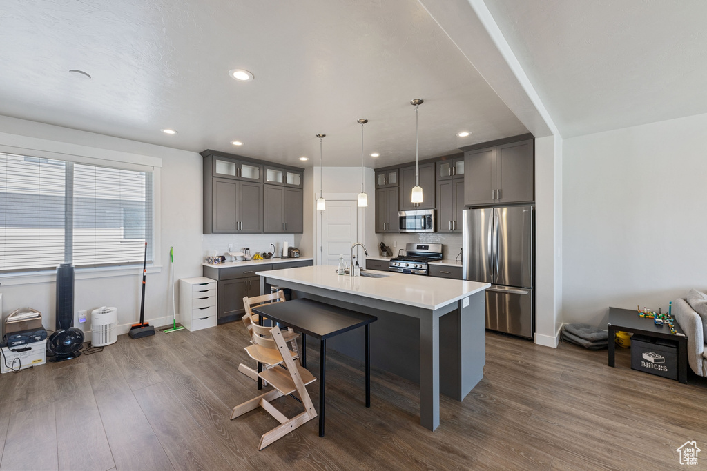 Kitchen with baseboards, recessed lighting, a sink, and stainless steel appliances