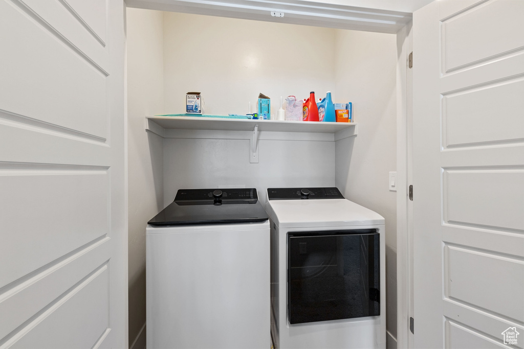 Washroom featuring laundry area and washer and clothes dryer