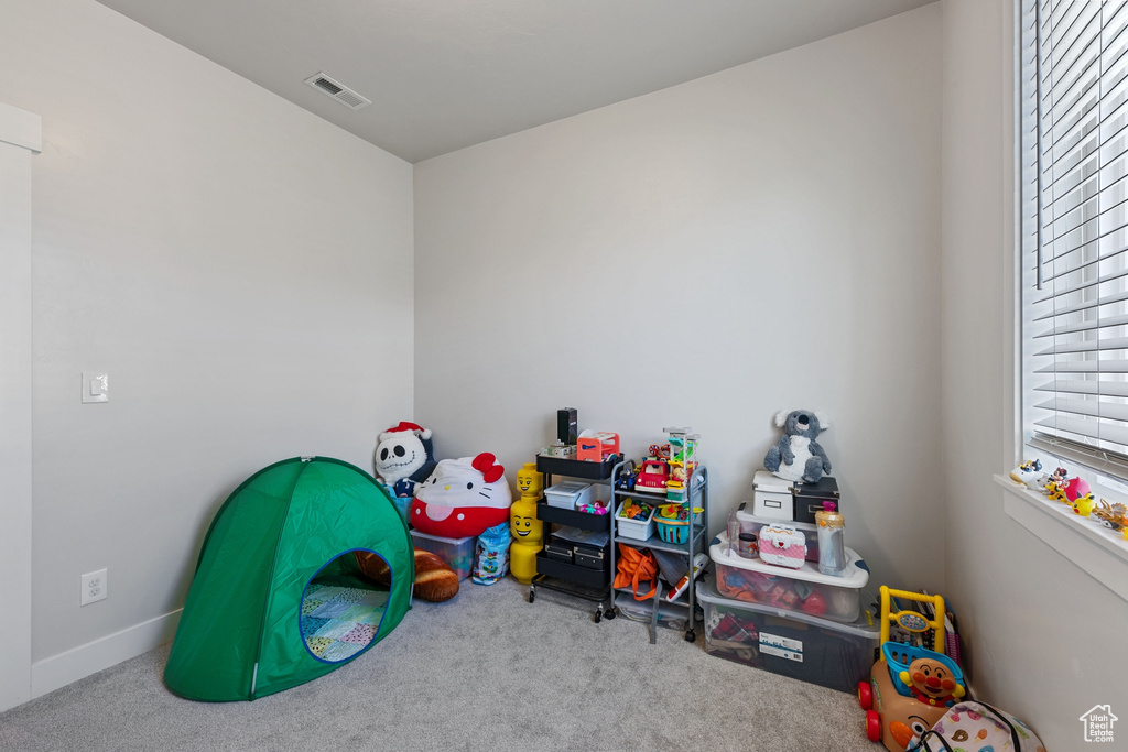 Rec room featuring plenty of natural light, carpet, and visible vents