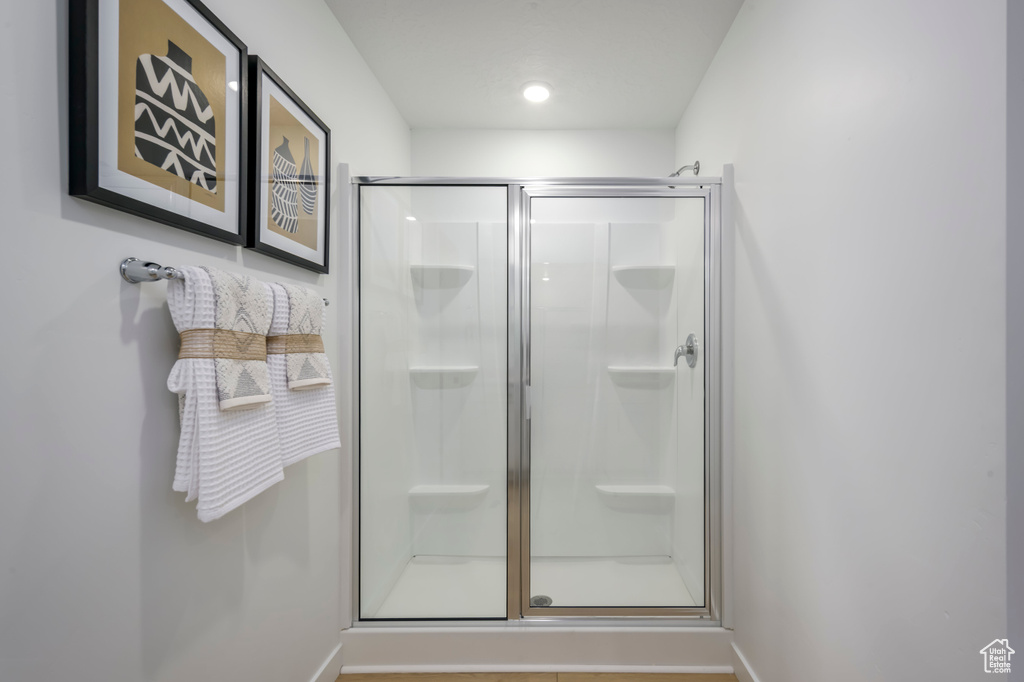 Bathroom with baseboards and a stall shower