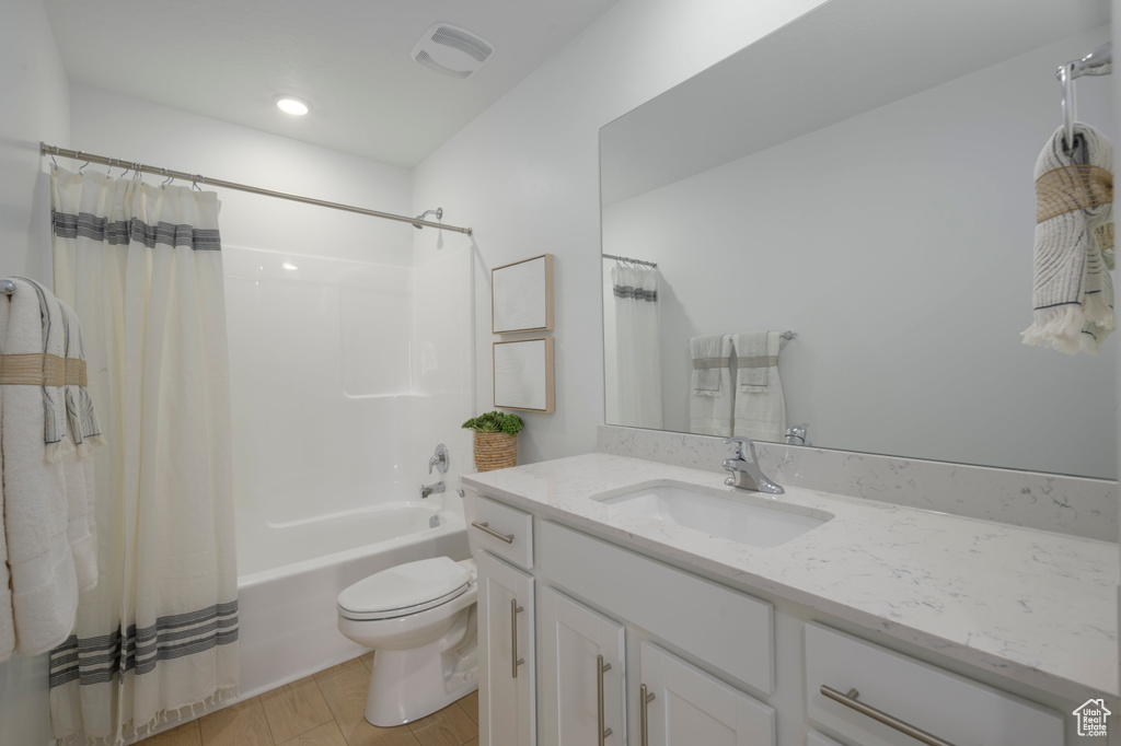 Bathroom with visible vents, shower / tub combo with curtain, vanity, toilet, and recessed lighting