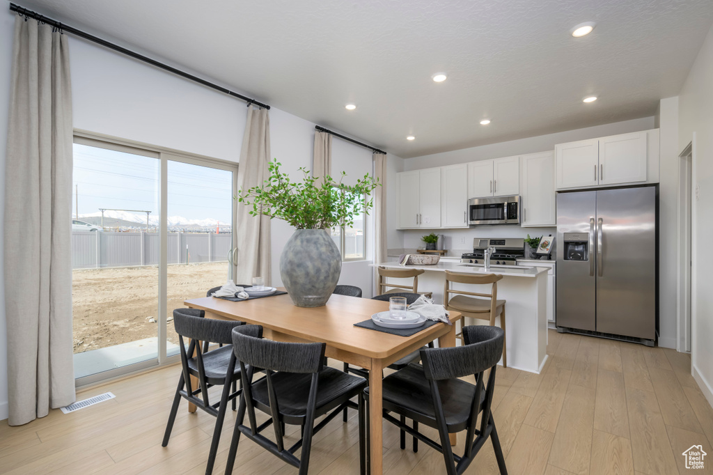 Dining space featuring recessed lighting, visible vents, and light wood-type flooring