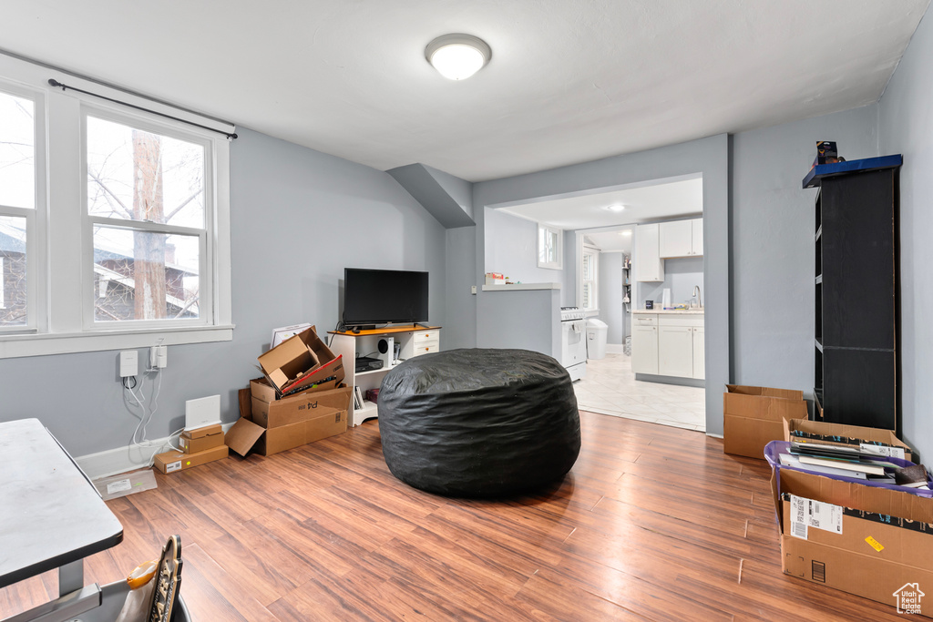 Living area with baseboards and light wood-type flooring