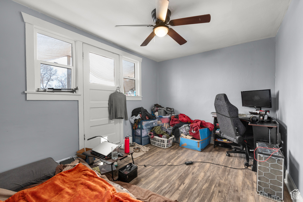 Home office with ceiling fan and wood finished floors