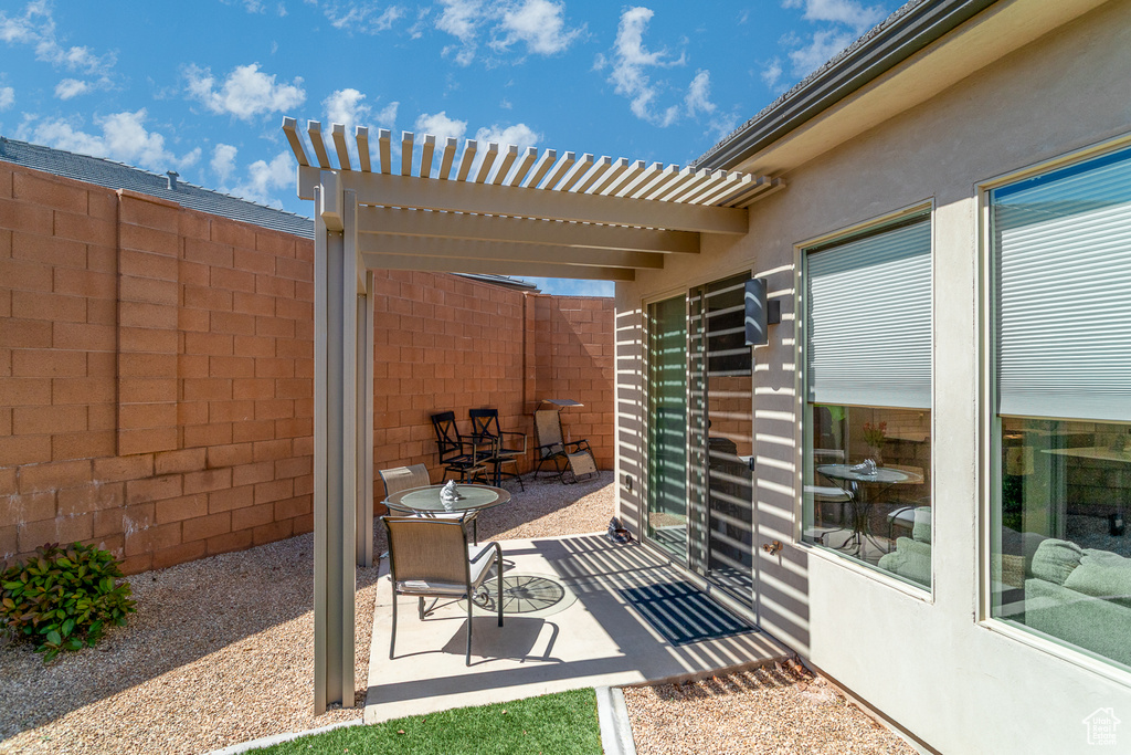 View of patio / terrace featuring fence and a pergola