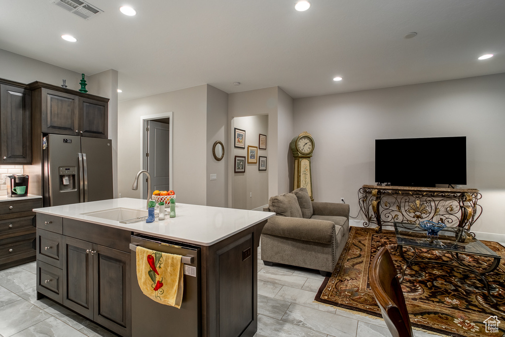 Kitchen with visible vents, appliances with stainless steel finishes, a sink, light countertops, and open floor plan