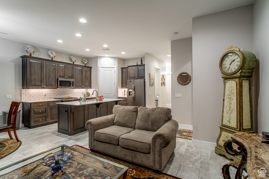 Living room featuring baseboards, marble finish floor, recessed lighting, and visible vents
