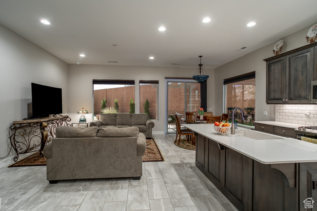 Living area with recessed lighting and marble finish floor