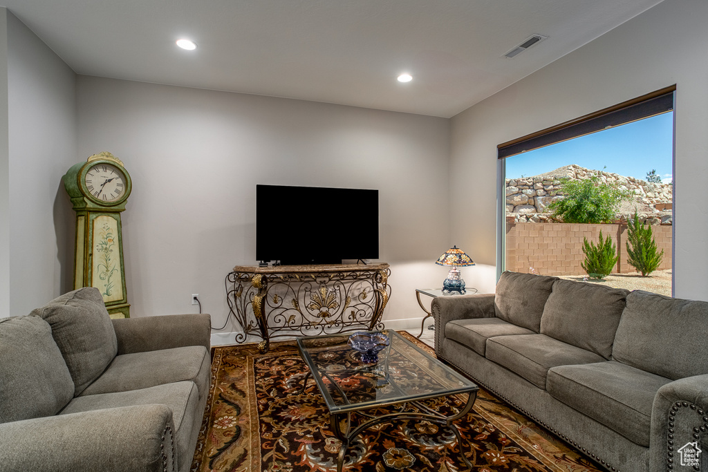 Living area with recessed lighting, baseboards, and visible vents