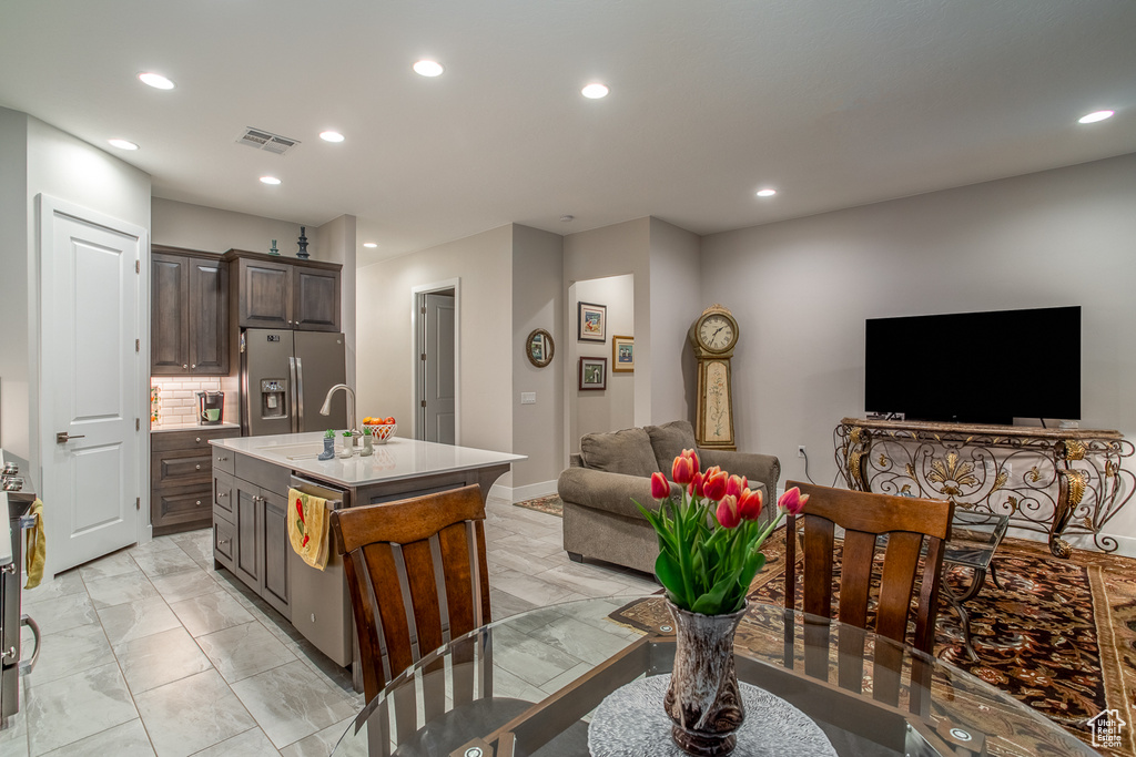 Kitchen with appliances with stainless steel finishes, a sink, marble finish floor, recessed lighting, and open floor plan