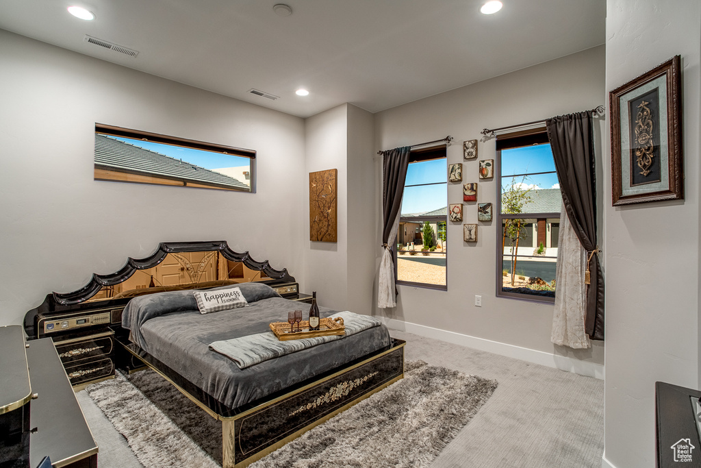 Carpeted bedroom featuring recessed lighting, baseboards, and visible vents