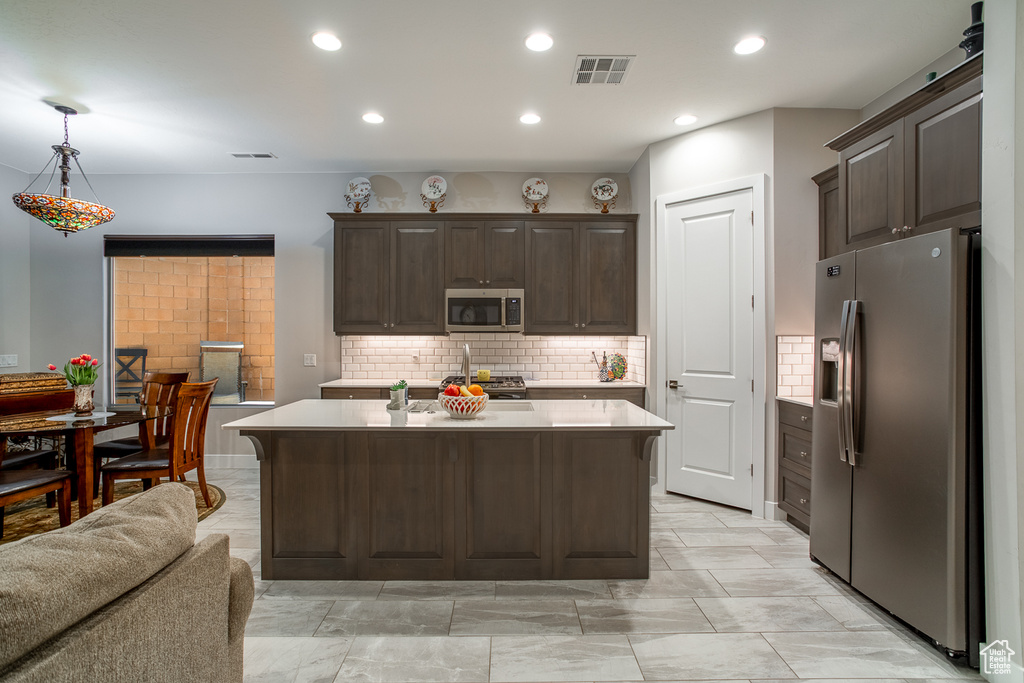 Kitchen with visible vents, light countertops, dark brown cabinetry, and stainless steel appliances