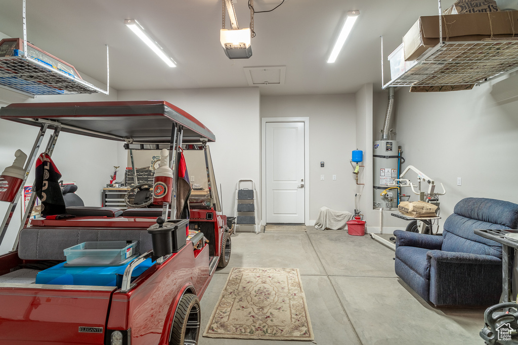 Garage featuring a garage door opener and water heater