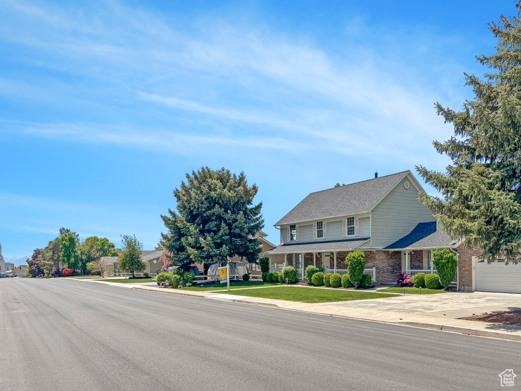 View of front of home featuring brick siding and driveway