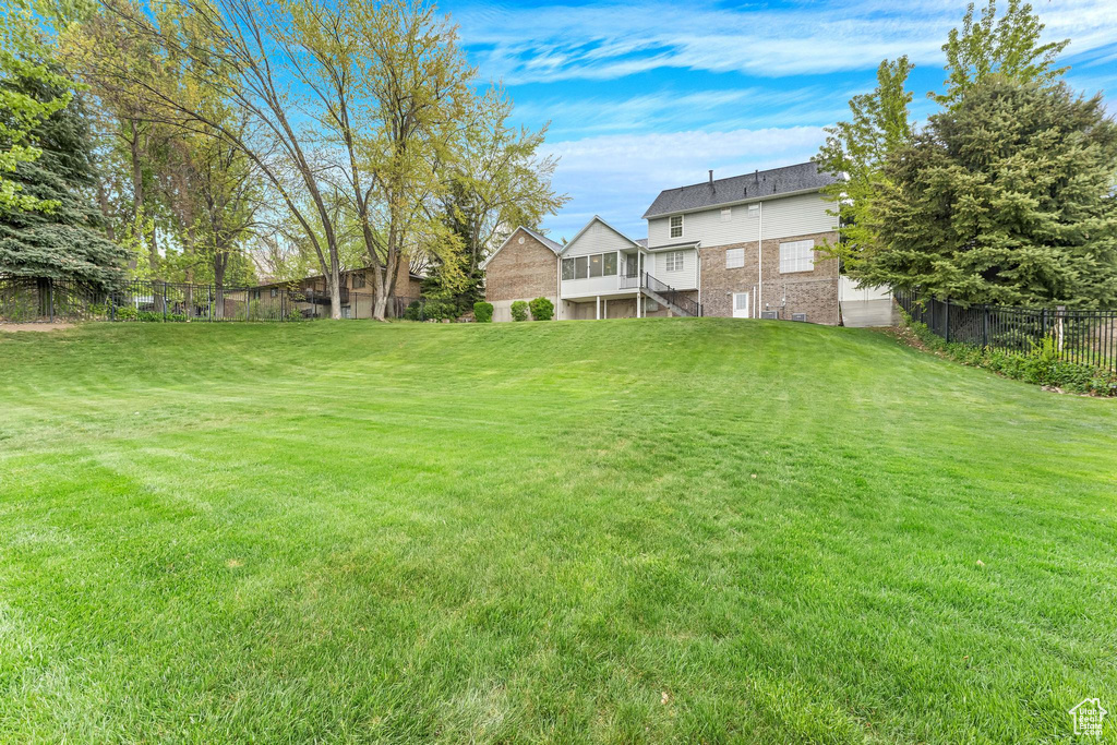 View of yard with stairs and fence