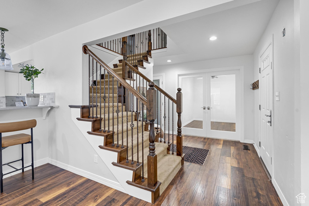 Interior space featuring recessed lighting, baseboards, french doors, and dark wood finished floors