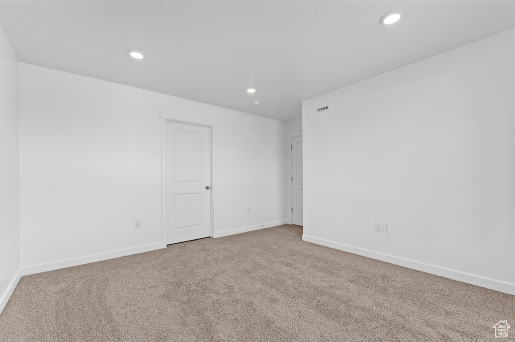 Carpeted empty room with recessed lighting, baseboards, and visible vents