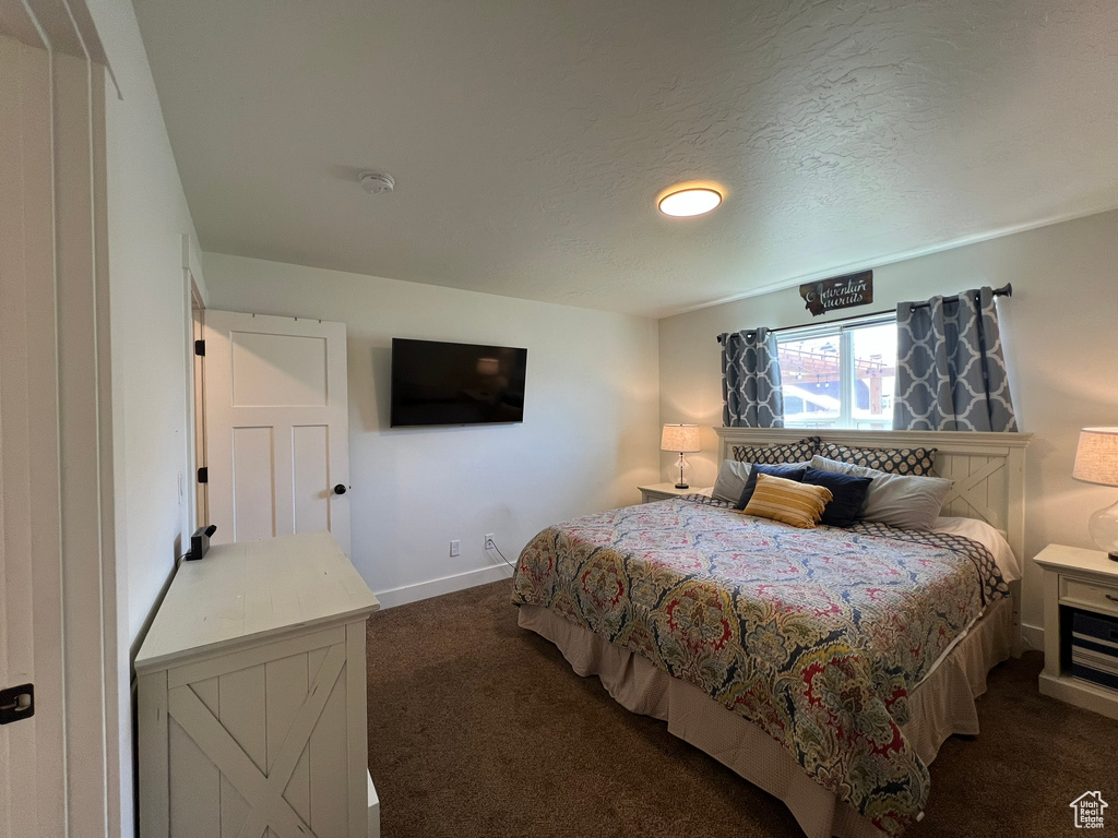 Bedroom featuring carpet flooring and baseboards