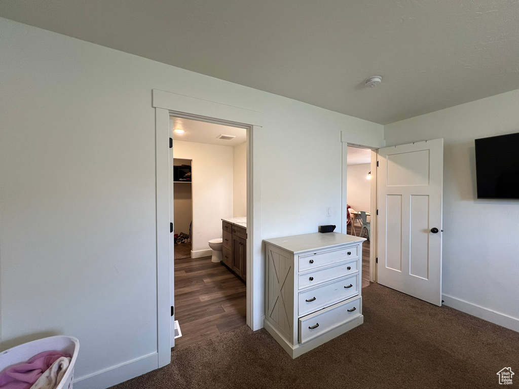 Bedroom featuring baseboards and dark colored carpet