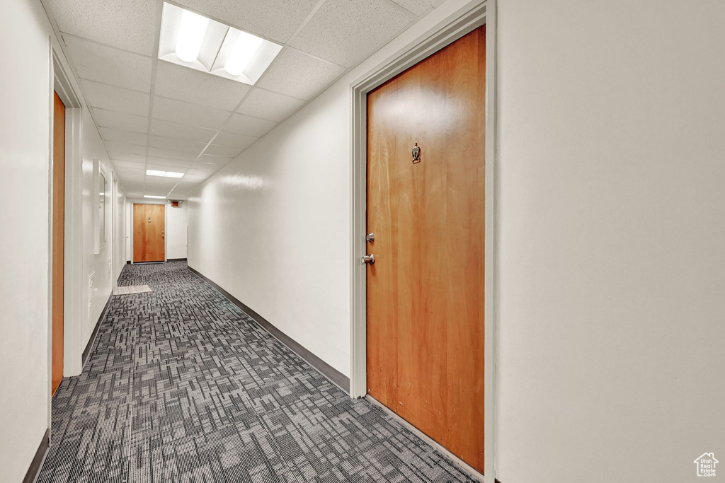 Hall featuring a paneled ceiling
