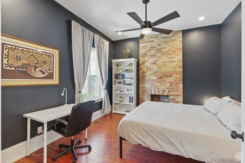 Bedroom featuring baseboards, vaulted ceiling, and wood finished floors