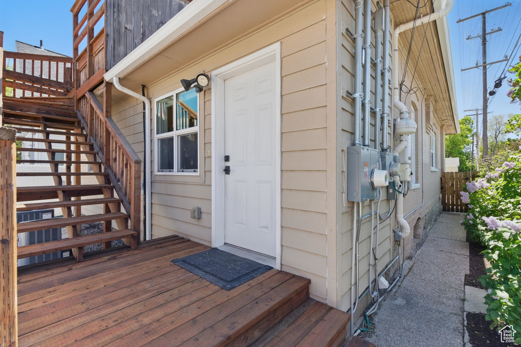 View of exterior entry with a wooden deck