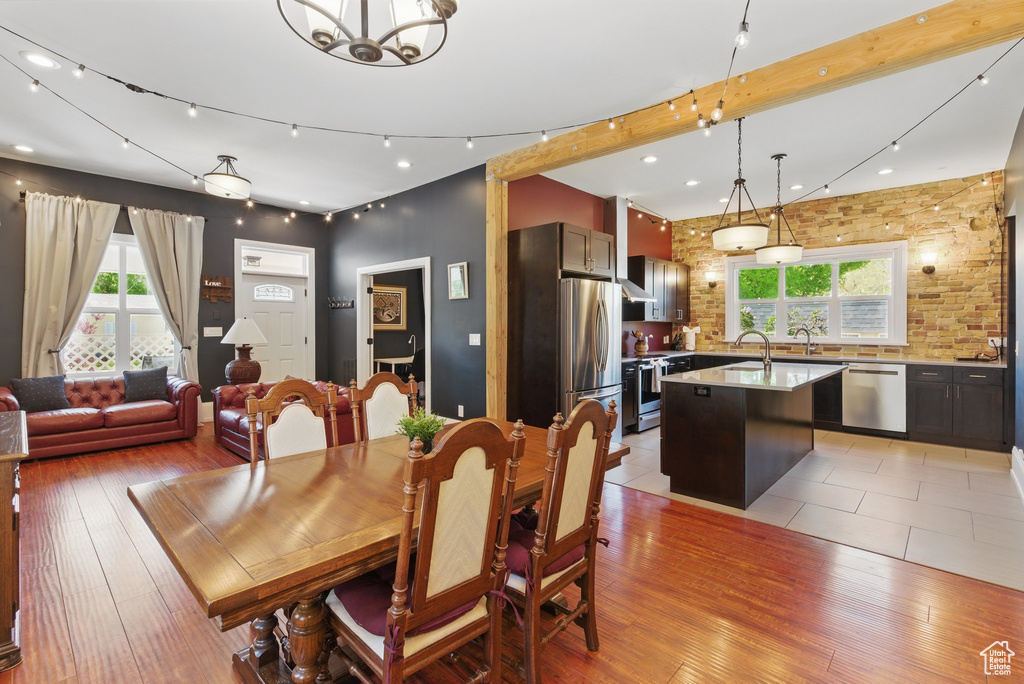 Dining area with an inviting chandelier, recessed lighting, and light wood-style floors