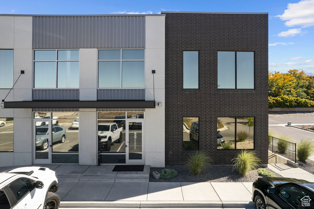 View of property featuring uncovered parking