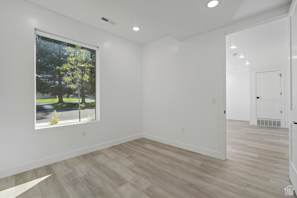 Spare room featuring recessed lighting, visible vents, and light wood-type flooring