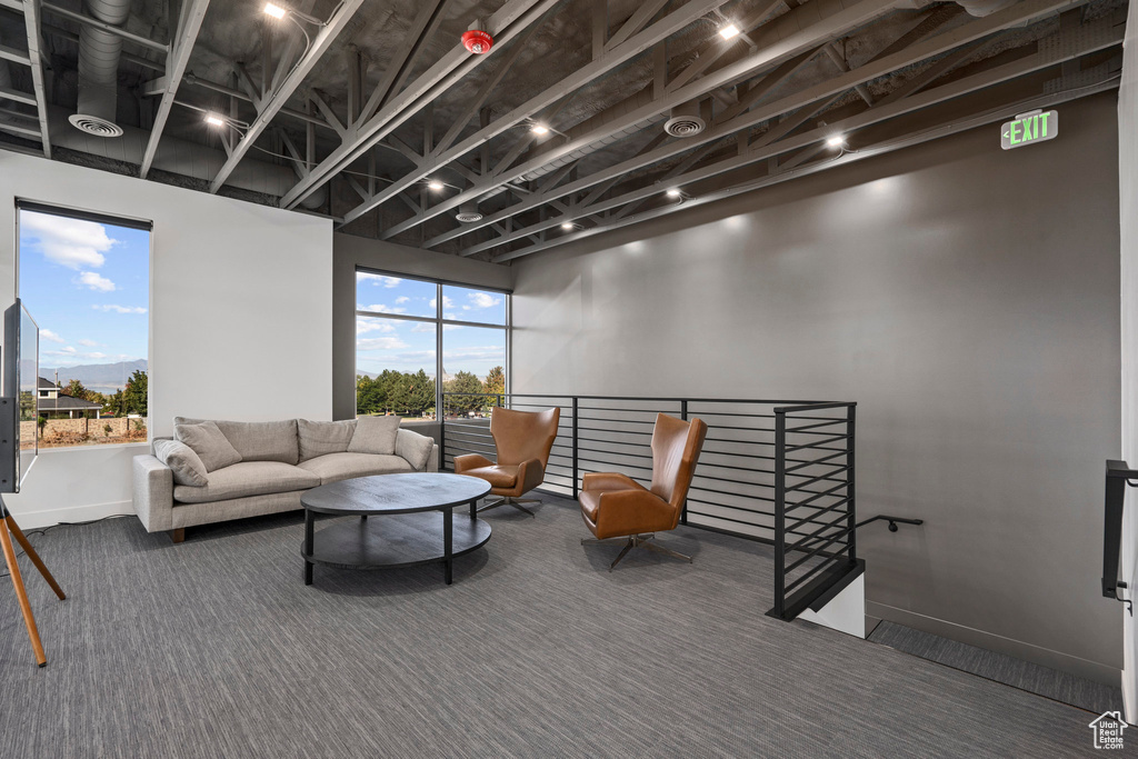 Carpeted living area with baseboards
