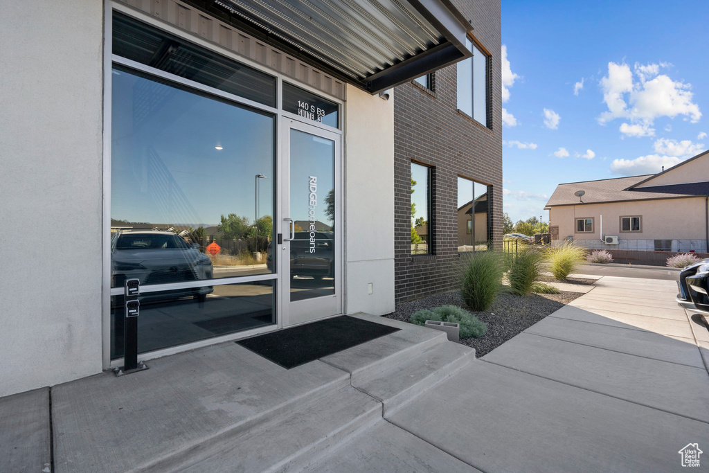 View of exterior entry featuring brick siding