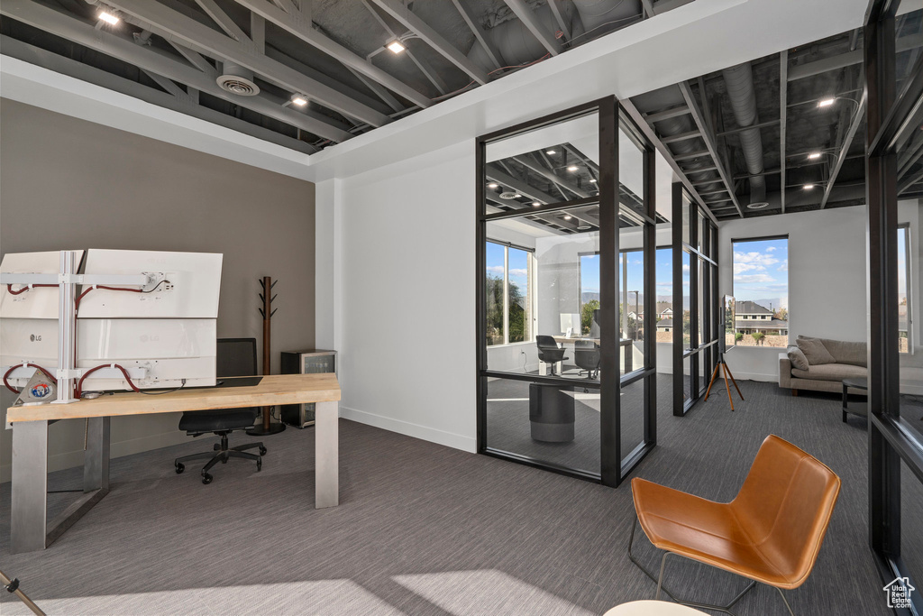 Home office featuring baseboards and carpet