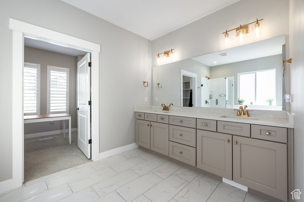 Full bathroom with a sink, a healthy amount of sunlight, and marble finish floor