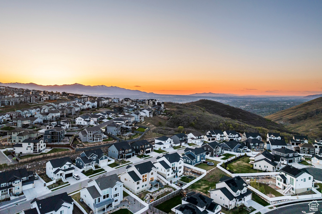 Aerial view at dusk featuring a mountain view and a residential view