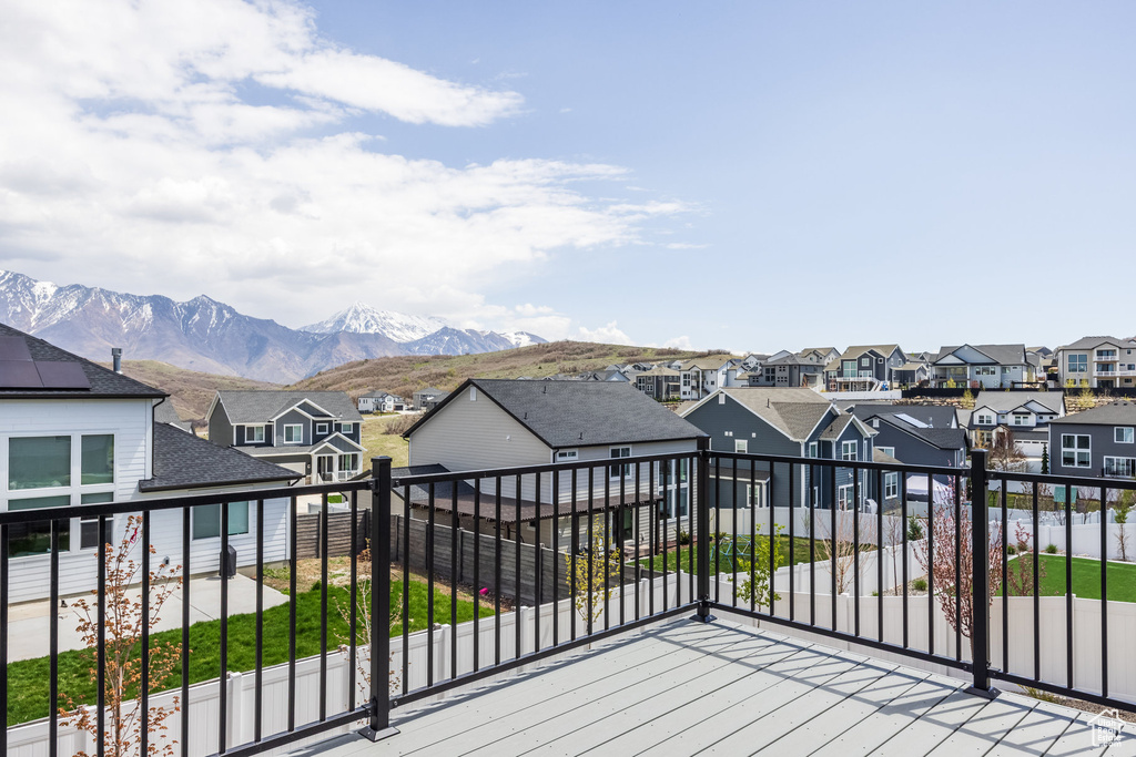 Wooden deck featuring a mountain view and a residential view
