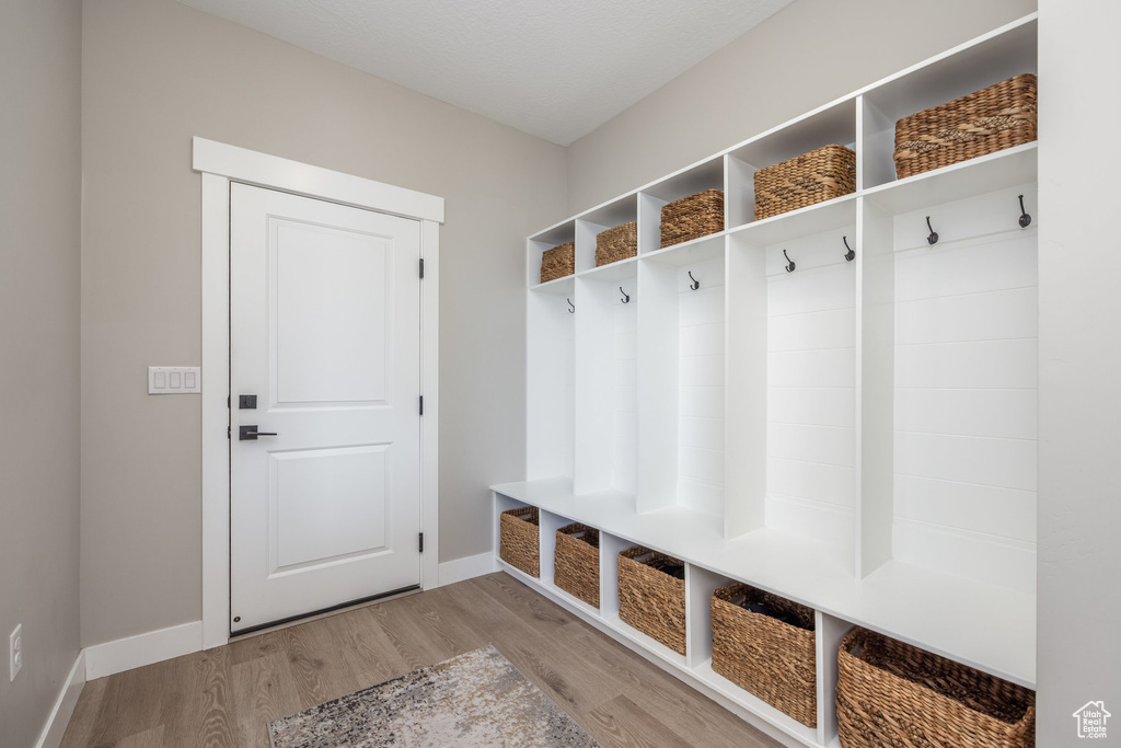 Mudroom with baseboards and wood finished floors