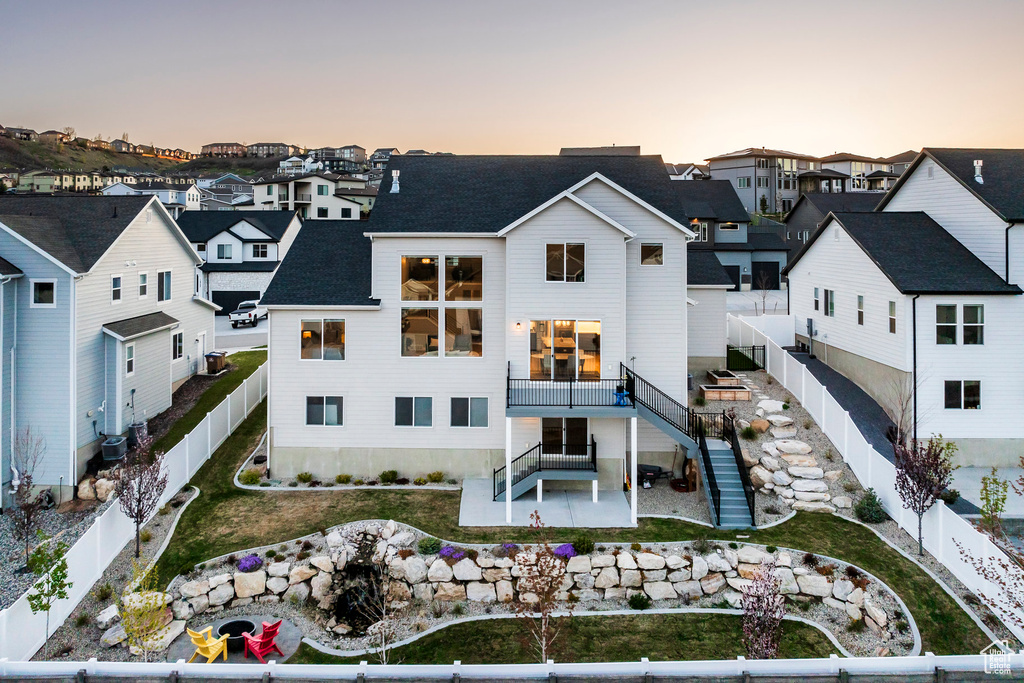 Exterior space with a patio area, a residential view, a fenced backyard, and stairs