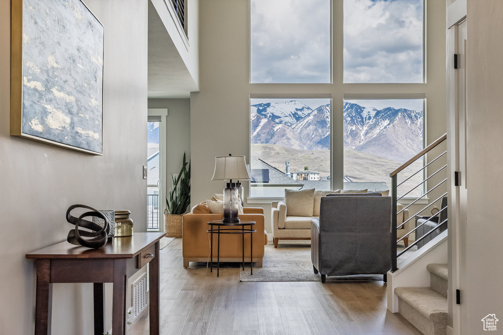 Sitting room featuring stairs, a mountain view, and wood finished floors