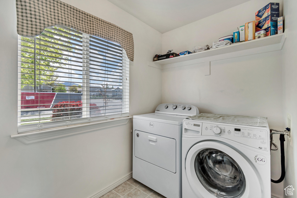 Laundry area featuring a healthy amount of sunlight, laundry area, and washing machine and clothes dryer