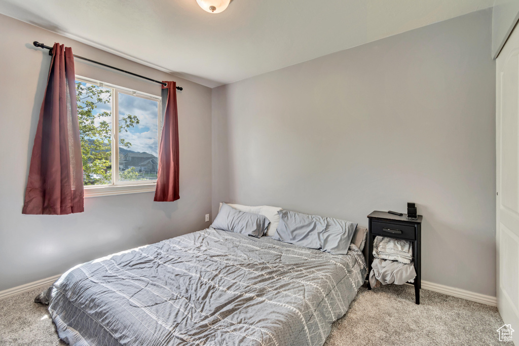 Carpeted bedroom with baseboards
