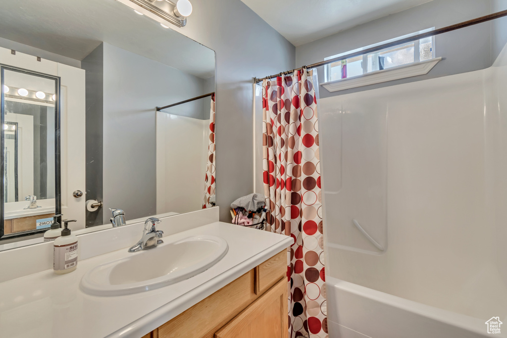 Full bath with vanity and shower / bath combination with curtain