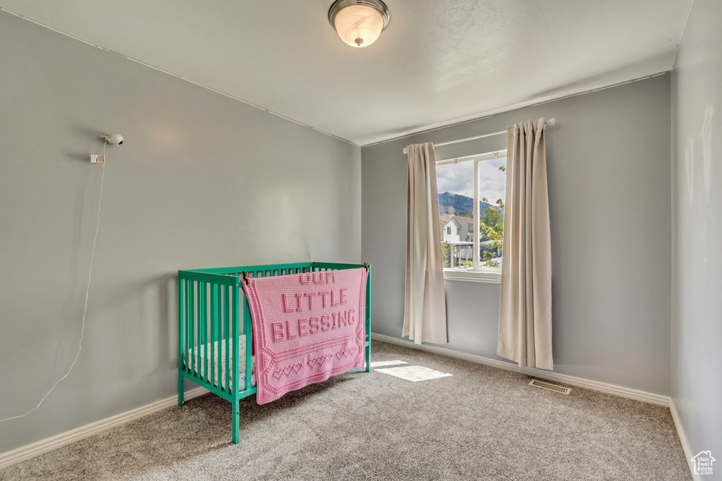 Bedroom with carpet floors, baseboards, and visible vents