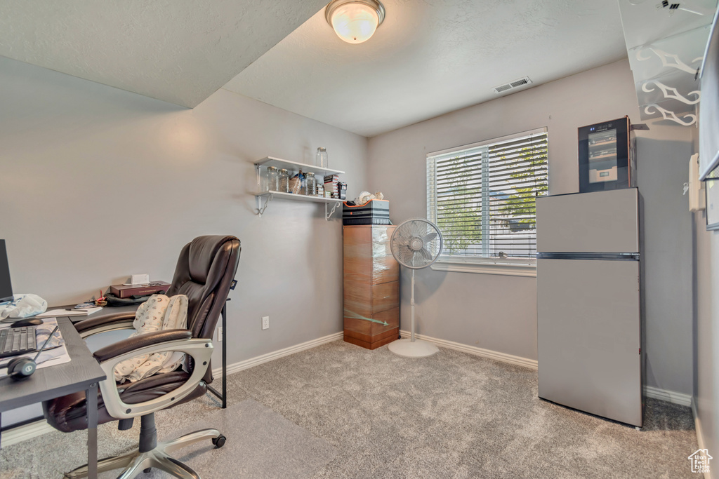 Office featuring baseboards, carpet flooring, and visible vents