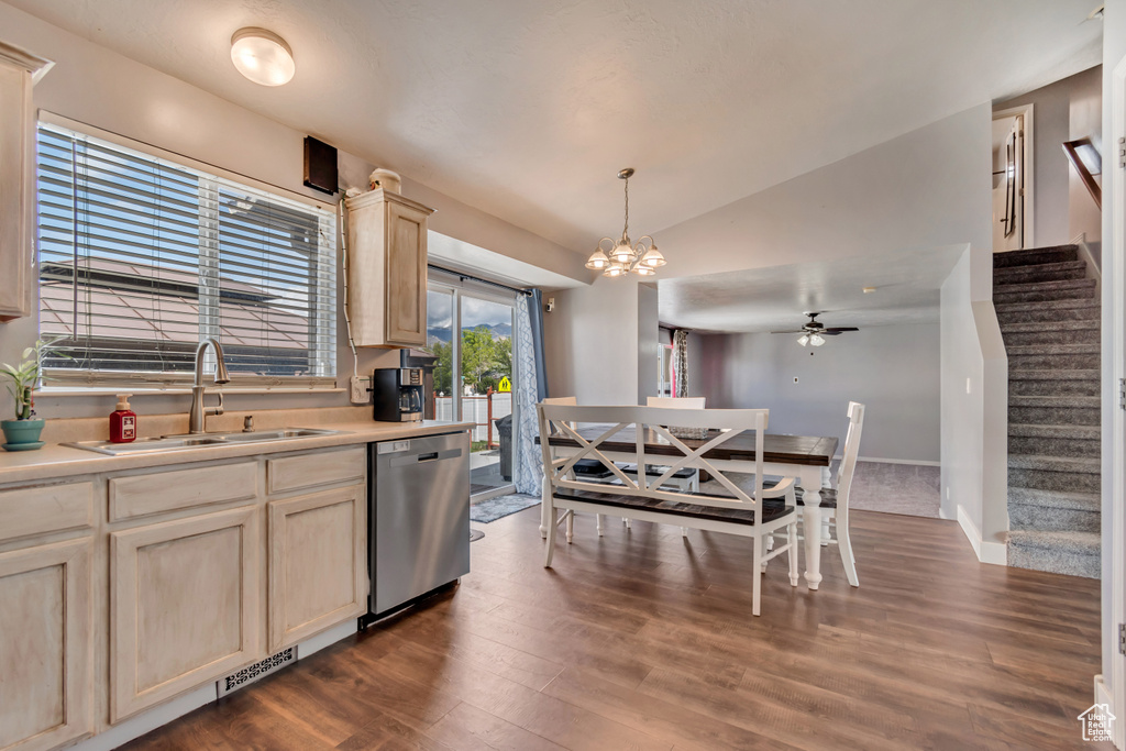 Kitchen with dark wood-style flooring, a sink, light countertops, lofted ceiling, and stainless steel dishwasher