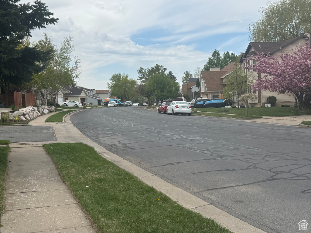 View of road featuring a residential view, sidewalks, and curbs