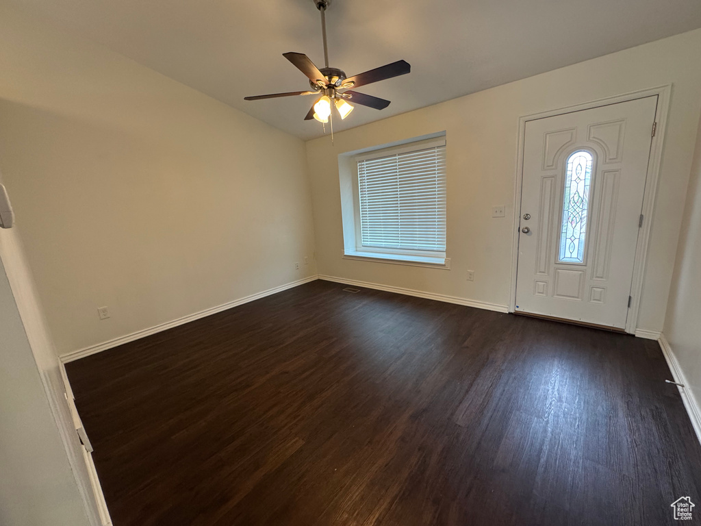 Foyer featuring baseboards, a ceiling fan, dark wood-style flooring, and vaulted ceiling