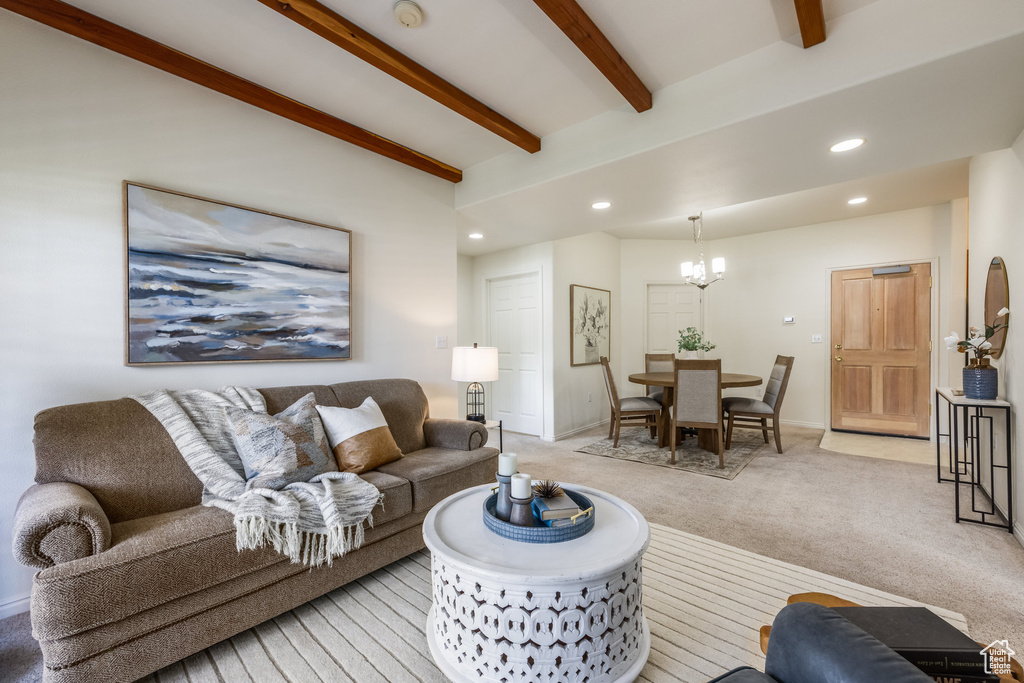 Living room with light colored carpet, an inviting chandelier, beam ceiling, recessed lighting, and baseboards
