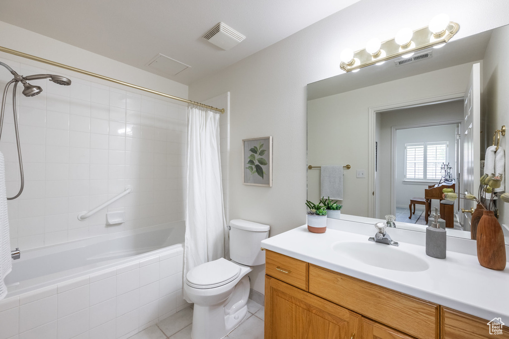 Bathroom featuring visible vents, tile patterned floors, toilet, and tiled shower / bath