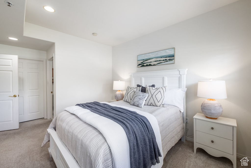 Carpeted bedroom with recessed lighting